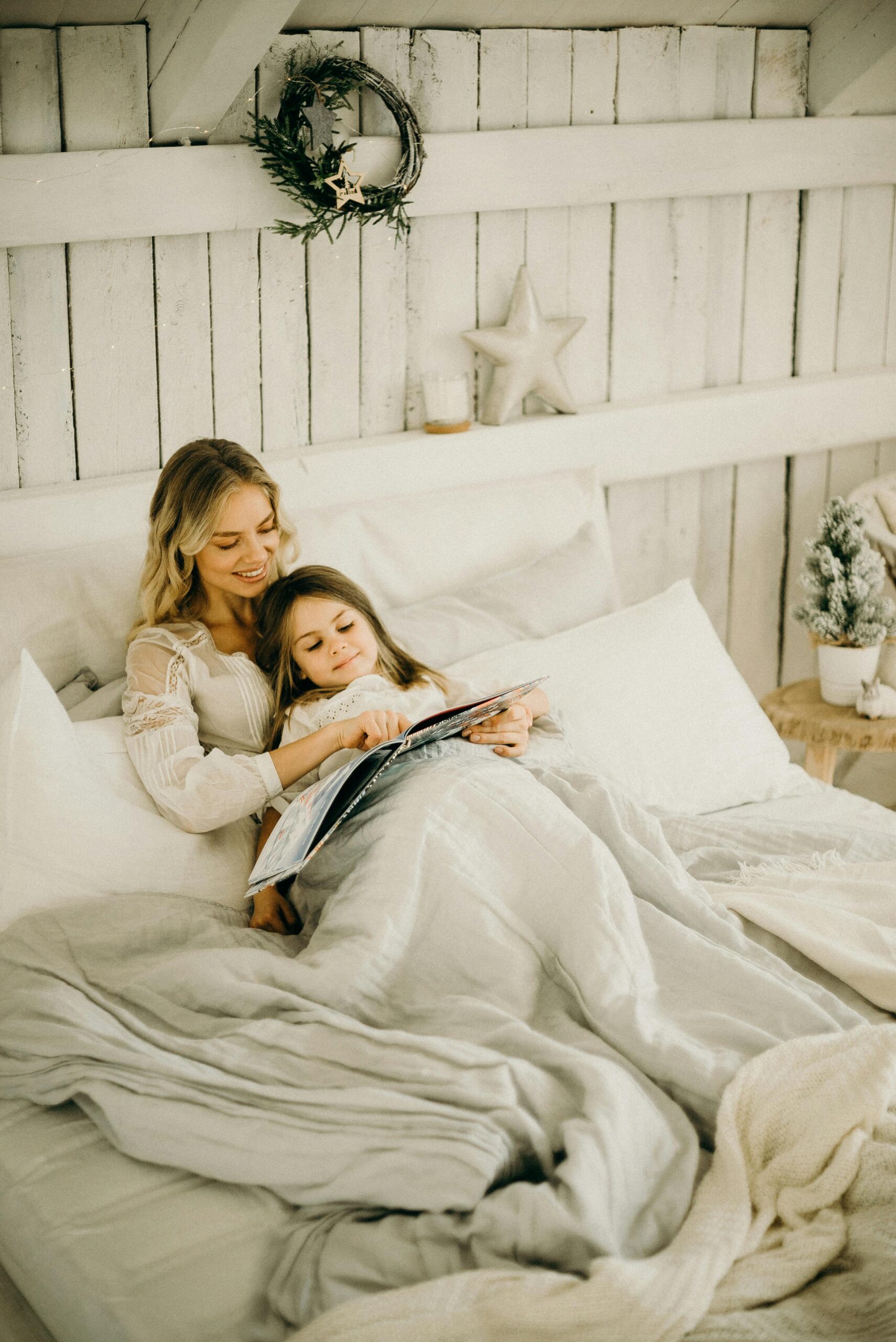 pexels photo 3171116 3171116 A mother and daughter enjoy a relaxing moment reading a book in a beautifully decorated bedroom.